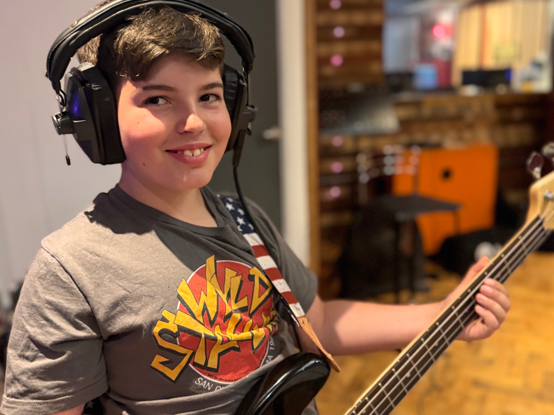 Student bass player wearing studio headphones