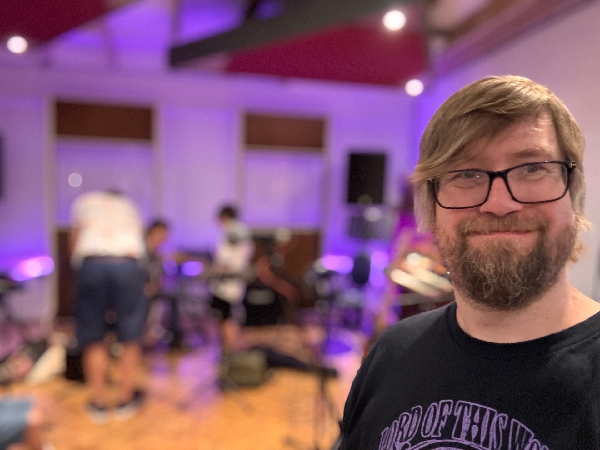 Cliff Ward in the studio with students recording behind him