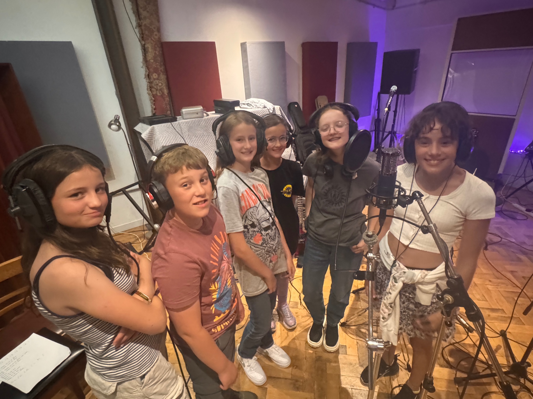 Students gathered around the vocal microphone