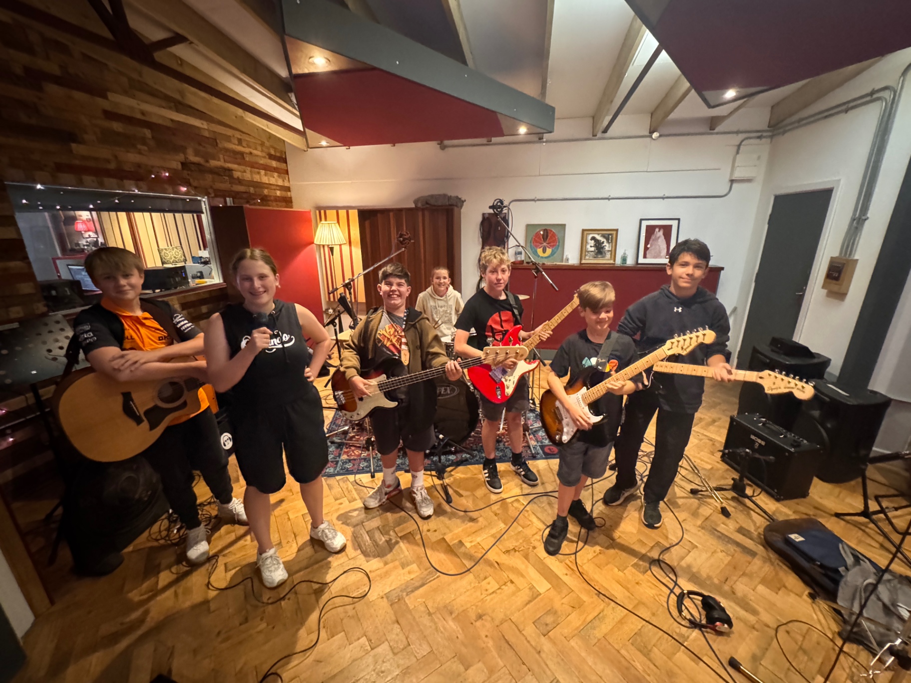 Group of students with their guitars in the studio
